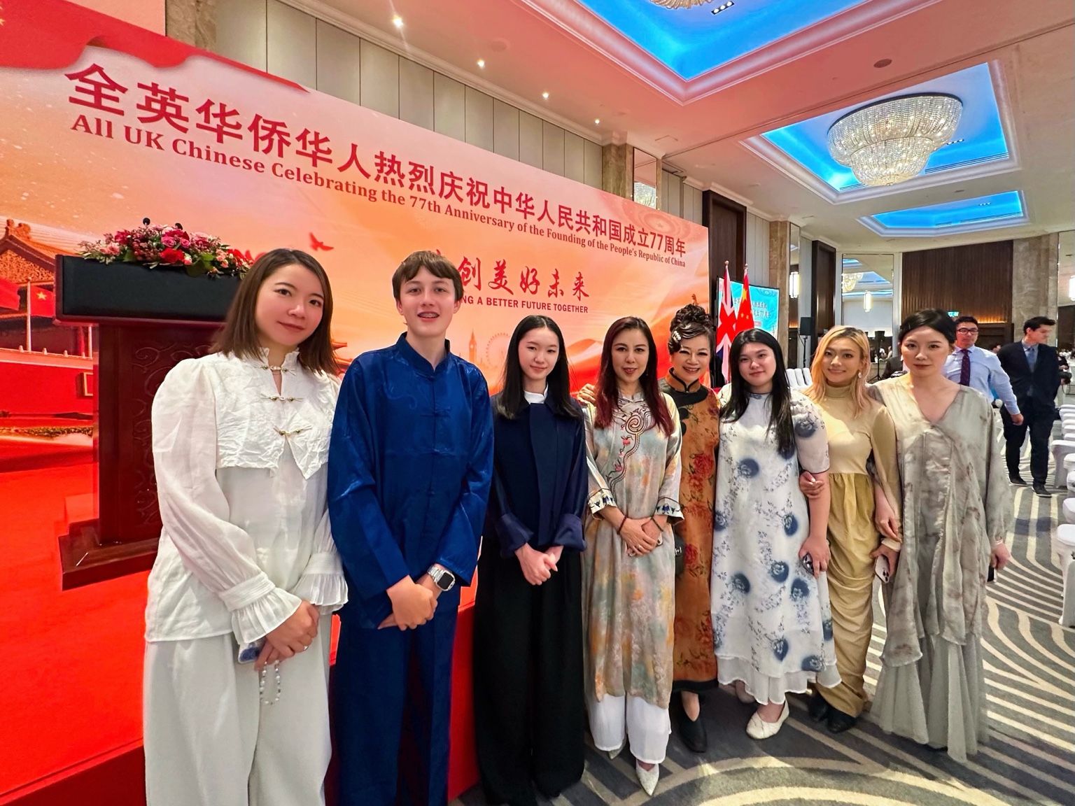 Performers in front of the celebration backdrop